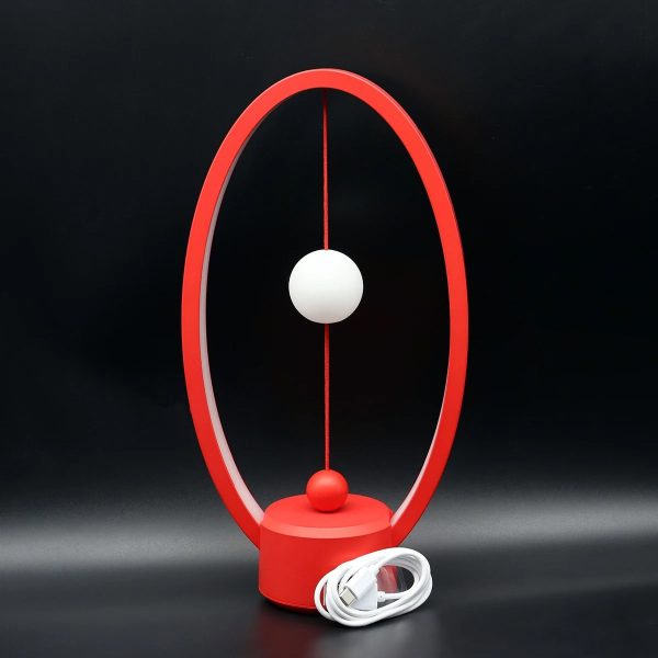 Lâmpada de mesa com estrutura circular vermelha, esfera branca suspensa e base circular vermelha, com cabo de energia branco.
