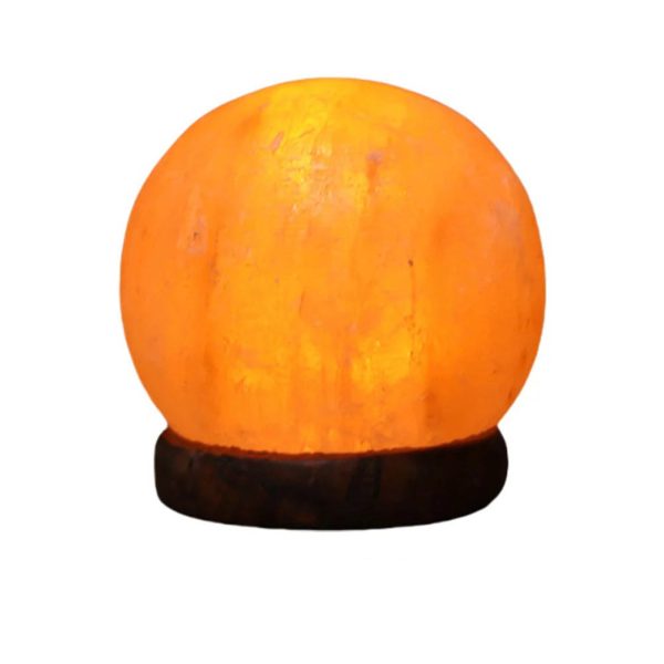Candeeiro de sal dos Himalaias em forma de esfera, iluminado, com base de madeira escura, destacando a textura do sal.