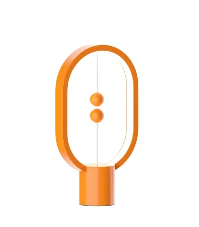 Lâmpada de mesa moderna em forma de oval laranja com dois botões no centro, ideal para decoração científica ou moderna.