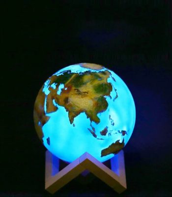 Lâmpada decorativa em forma de planeta Terra com continentes visíveis, iluminada com luz azul, colocada numa base de suporte.