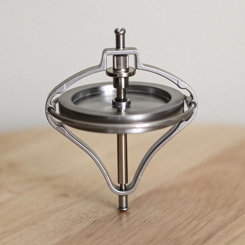 Giroscópio de metal com estrutura circular e eixo central, usado para demonstrações de física e efeitos de anti gravidade.