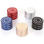 Conjunto de cinco giroscópios anti-stress em cores diferentes: vermelho, branco, azul, dourado e preto, com padrão de espiral na parte superior.
