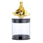 Pião giroscópio dourado com base transparente, visto de cima, destacando o movimento e o design elegante.