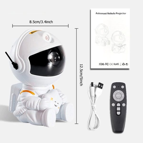 Mini projetor de nebulosa com design de astronauta, incluindo controle remoto, cabo USB e manual de instruções, com dimensões de 8,5cm por 12,5cm.