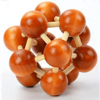 Estrutura de modelo de átomo com esferas de madeira laranja e varetas brancas, representando partículas subatómicas, vista frontal.