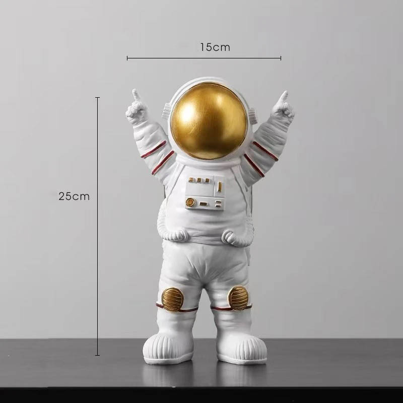 Estatueta de Astronauta Vitorioso Estatueta de astronauta com capacete dourado, traje branco com detalhes vermelhos e acessórios em relevo, medindo 25cm de altura e 15cm de largura.