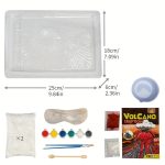 Bacia de plástico transparente com marcações, pacote de reagentes, óculos de proteção, pipetas, colher de madeira, e embalagem do kit de vulcão em destaque.