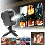 Projetor holográfico a projetar imagens de abóboras assustadoras e mãos fantasmagóricas na parede, com uma lente ajustável e suporte.