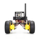 Robô com rodas grandes, câmera na frente, antena e componentes eletrônicos visíveis, usado para projetos de robótica educativa.