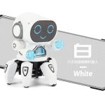Robô branco com rosto digital sorridente, braços de luz azul, pernas articuladas e caixa de som, ideal para atividades educativas e de ciência.