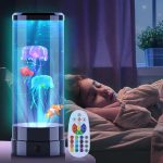 Candeeiro de lava com peixes luminosos, controle remoto, luzes coloridas e efeito de lava em movimento, colocado ao lado de uma criança a dormir.