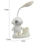 Luminária de mesa com figura de astronauta com cabeça espelhada e braço articulado com luz LED, base com suporte para telemóvel, dimensões 13x7.2x31cm.