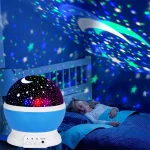 Projetor de luz de estrelas com efeito de estrelas e lua, iluminando o quarto de uma criança enquanto ela dorme.