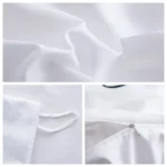Detalhes de tecido de algodão branco, incluindo costura, dobra e fecho de zíper, vistos de perto.