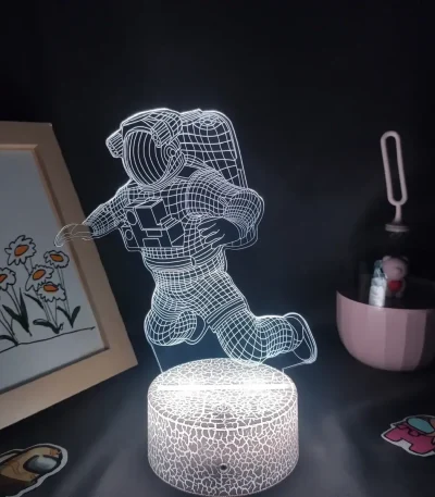 Lâmpada 3D de astronauta em queda, com efeito de luz LED, sobre base de pedra artificial, decorativa para quarto ou escritório.
