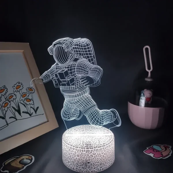 Lâmpada 3D de astronauta em queda, com efeito de luz LED, sobre base de pedra artificial, decorativa para quarto ou escritório.