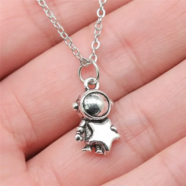 Colar com pingente de astronauta em metal prateado, ideal para amantes de ciência e exploração espacial.