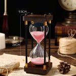 Porta-ampulheta vintage com areia rosa, mede 24 cm de altura e 9,5 cm de largura, ideal para decoração científica ou como objeto de coleção.