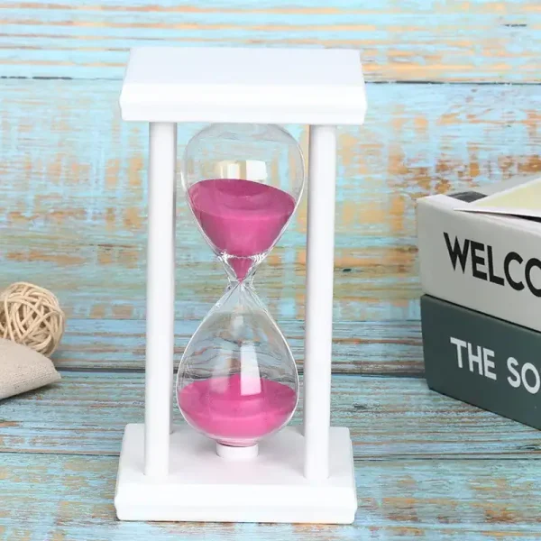 Pêndulo ampulheta de vidro com areia rosa, decoração científica elegante.