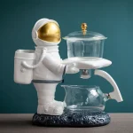 Figura de astronauta em plástico branco com um laboratório de vidro, decoração de estilo científico e espacial.