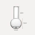 Frasco de vidro de laboratório com capacidade de 7,5 cm de altura e 5,5 cm de diâmetro, ideal para experiências científicas ou decoração.