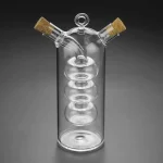 Vaso de vidro científico com duas rolhas de cortiça, ideal para a decoração ou utilização em laboratório. O seu design elegante e transparente faz dele um objeto decorativo único para os amantes de ciência.