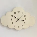 Relógio de parede em forma de nuvem branca em madeira com números pretos e ponteiros modernos, ideal para uma decoração original e lúdica.