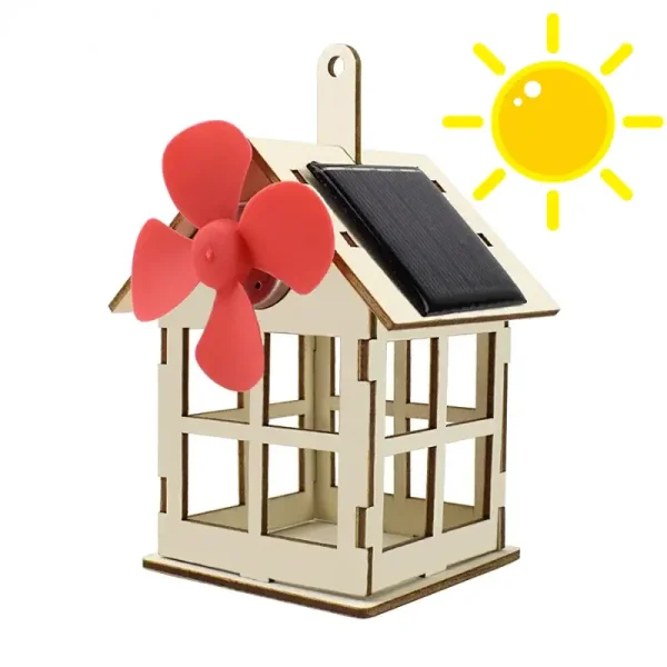 Modelo de pequena casa solar com moinho de vento em plástico rosa e painel solar preto, ilustrando uma turbina eólica doméstica ecológica.