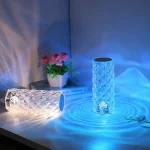 Vaso de vidro transparente com iluminação LED azul, ideal para decoração interior, ambiente moderno e elegante, perfeito para destacar flores e objetos decorativos.