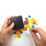 Peça LEGO científica com caixa preta e peças coloridas para experiências educativas e atividades de ciência para crianças.