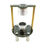 Pedal de síntese sonora vintage com componentes metálicos e fiação visível, usado para criar sons eletrônicos experimentais.